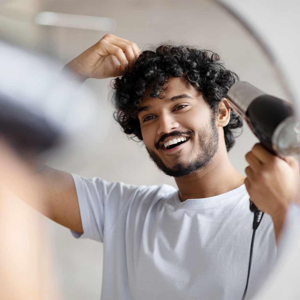 Man Blow Drying Hair