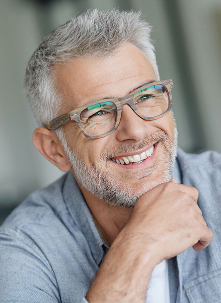 Man with glasses smiling